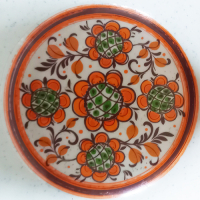 Schaal van Winterling met oranje bies en oranje bloempatroon