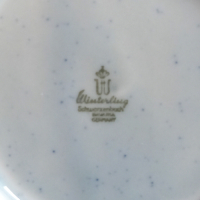 Schaal van Winterling met oranje bies en oranje bloempatroon